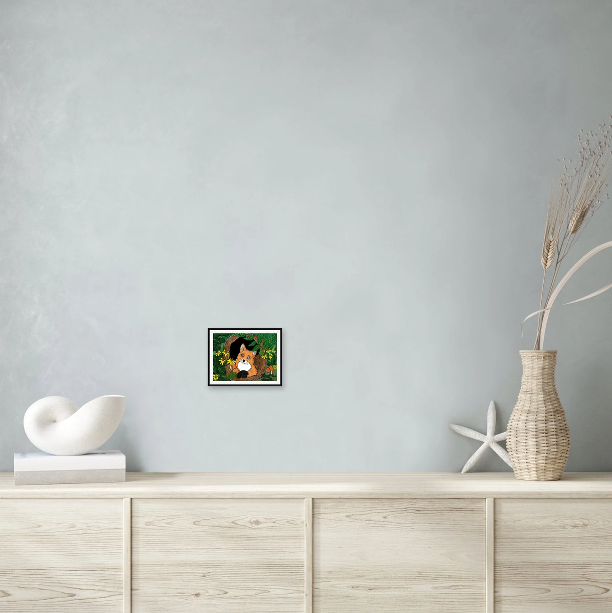 This is a small 8 x 10 matted and framed watercolor art print of a fox curled inside a hollow log among black-eyed Susans. Created by professional artists, this high-quality watercolor print on textured matte paper adds a touch of character to any home or office decor.