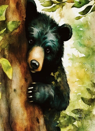 Black Bear Cub Peeking out from Behind a Tree