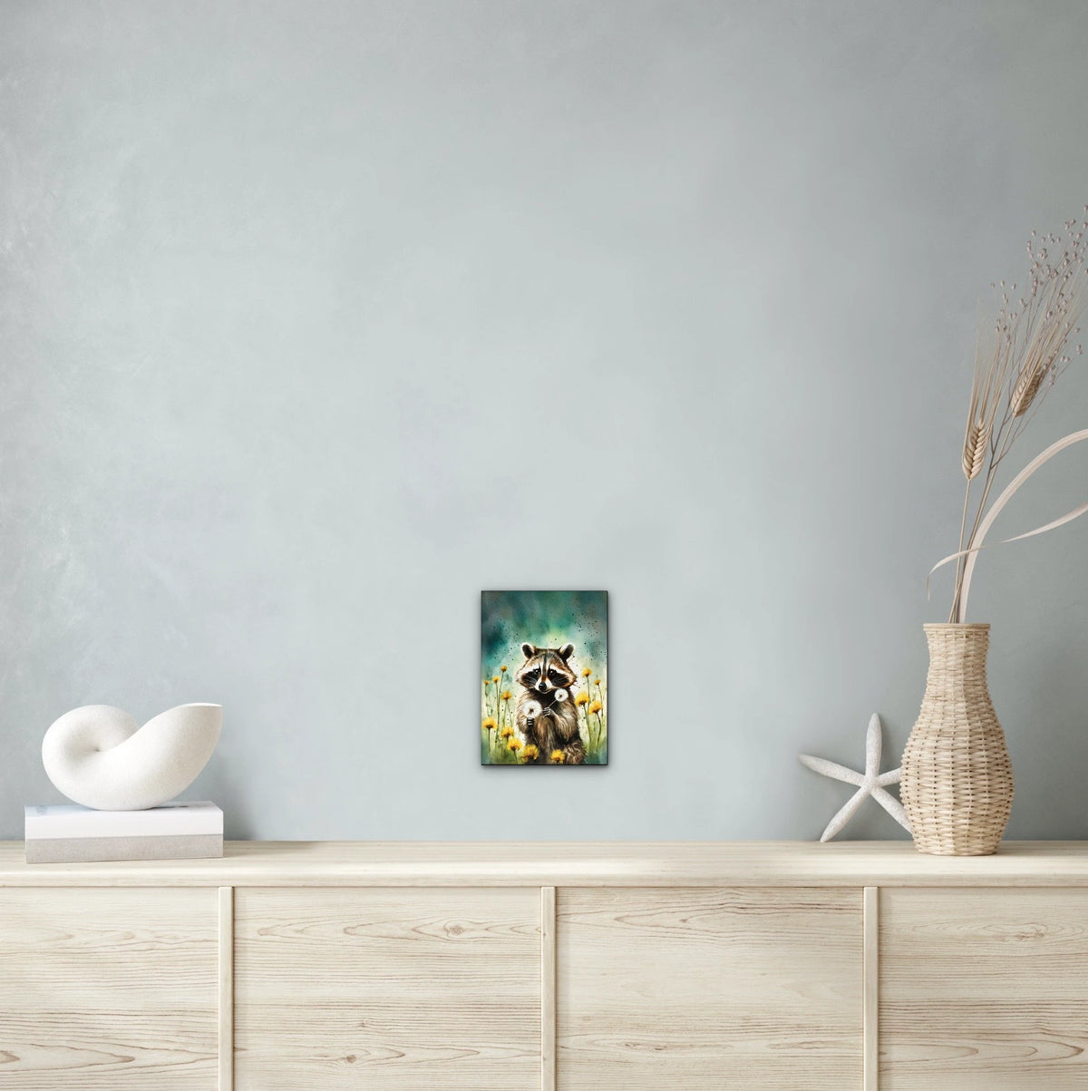 Raccoon Among Dandelions - medium 12 x 16 unframed art print shown hanging on a wall