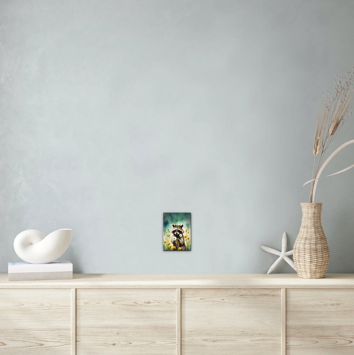 Raccoon Among Dandelions - small 8 x 10 unframed art print shown hanging on a wall
